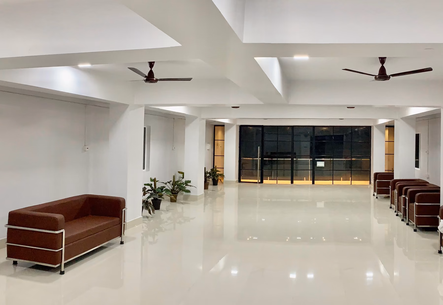 Bright banquet hall at Shanti Regency with open floor space and seating