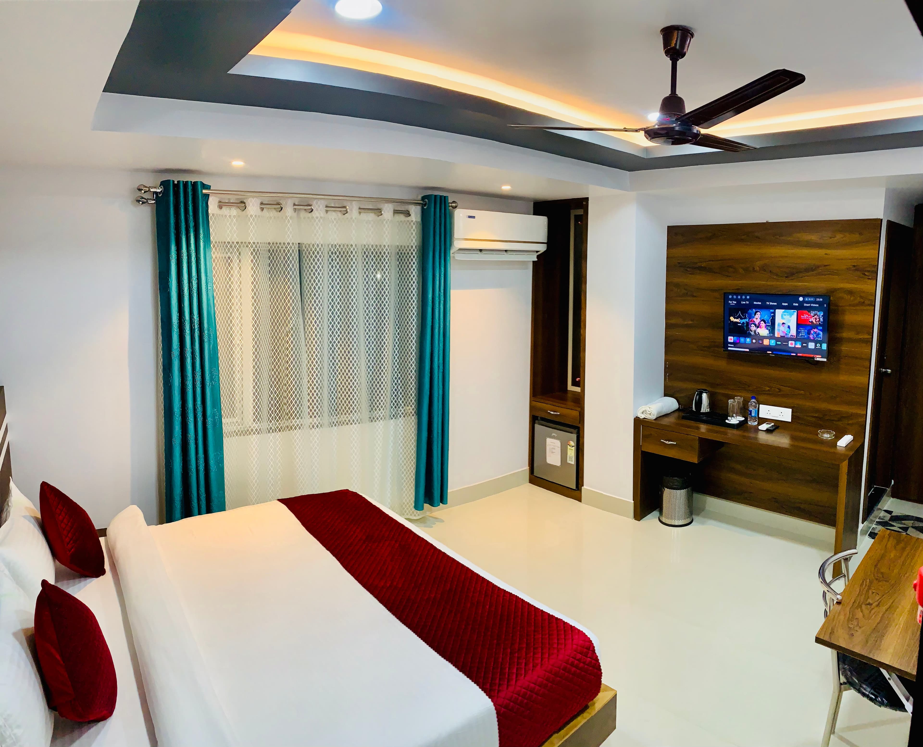 Premium room at Shanti Regency with bed, air conditioning, television and work desk
